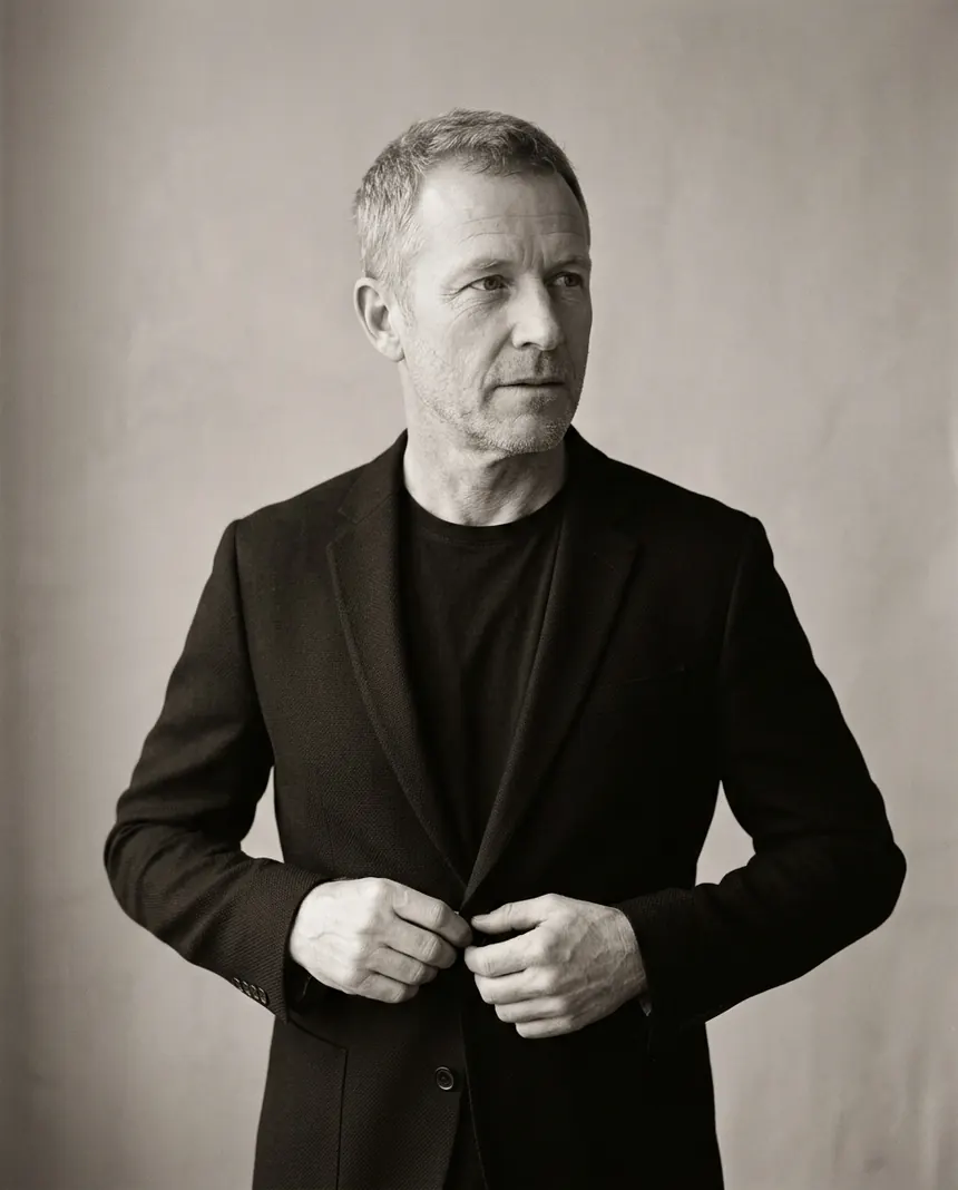 Owen Dunn buttoning a dark jacket